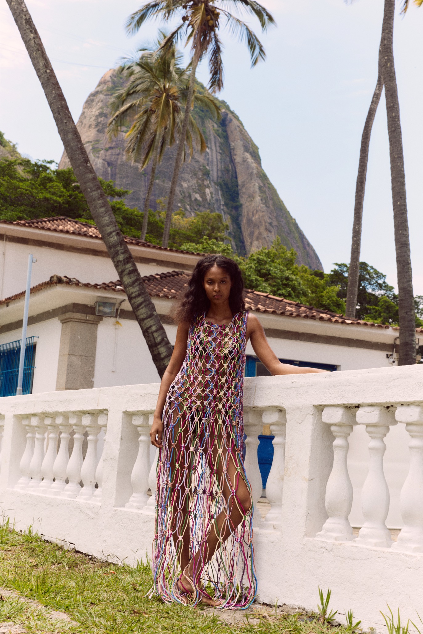 Magali Pascal ALEGRIA campaign, macramé dress by a balustrade in Urca