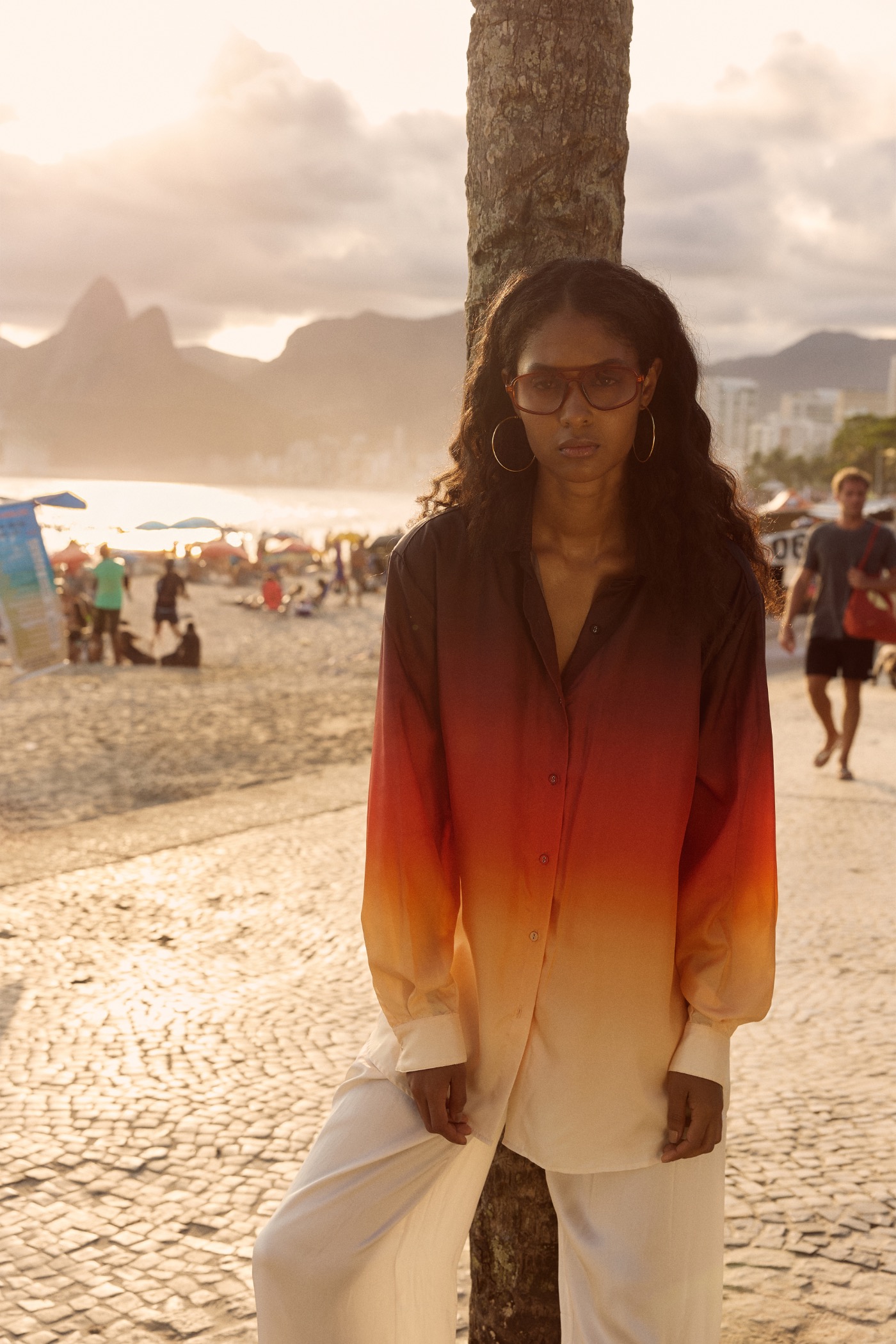 Magali Pascal ALEGRIA campaign, ombré shirt against a palm tree on the beachfront
