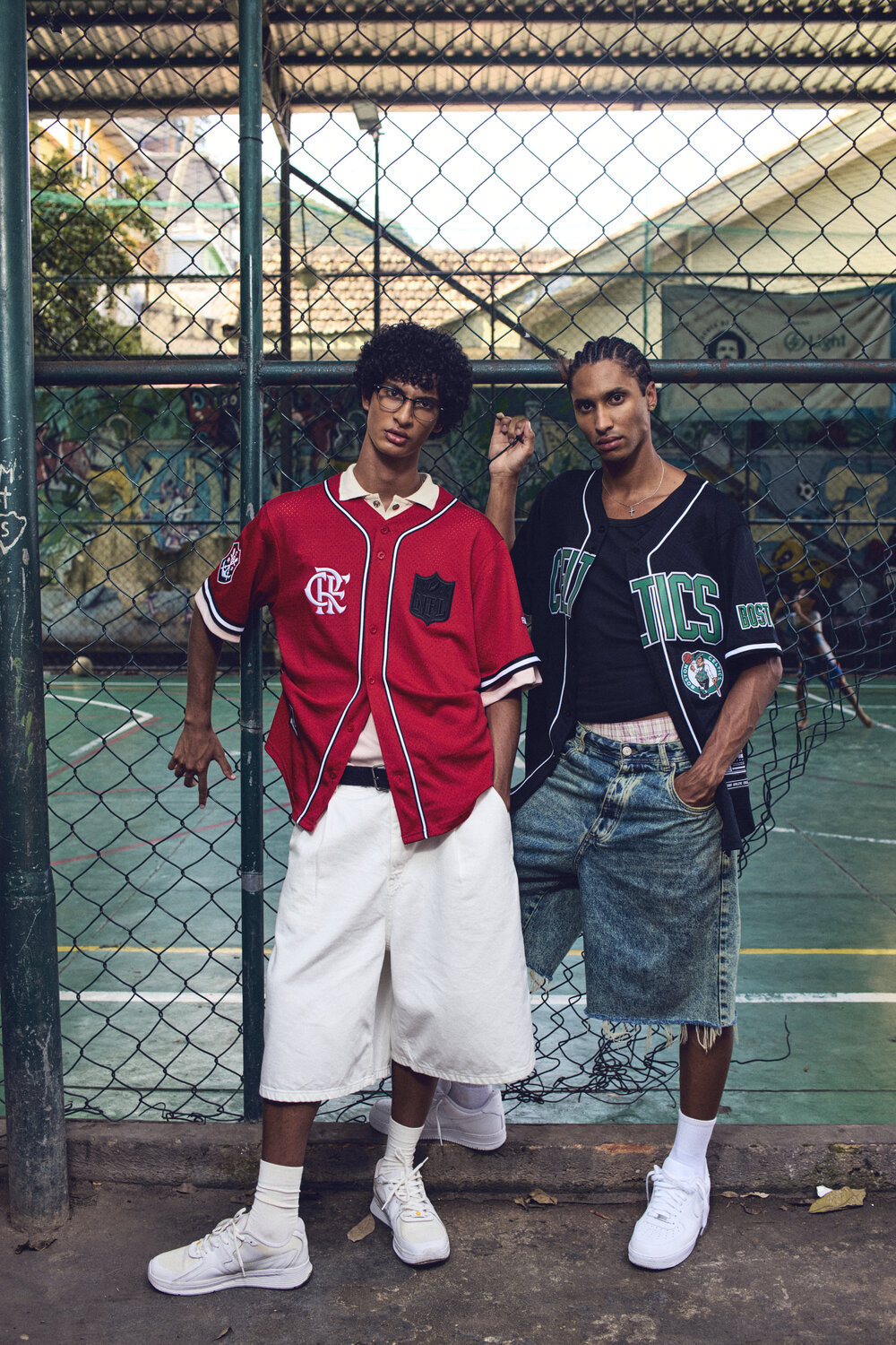 ProStandard NFL × Flamengo campaign, two models at the court fence in the red CRF and black team jerseys